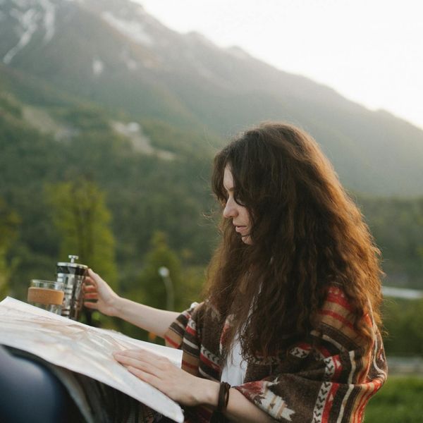 Person looking out over a calm landscape at dawn.